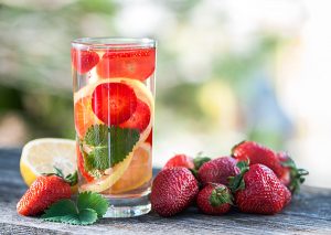 glass of orange and strawberry infused water
