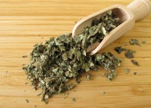 dried butterbur leaves on wooden table