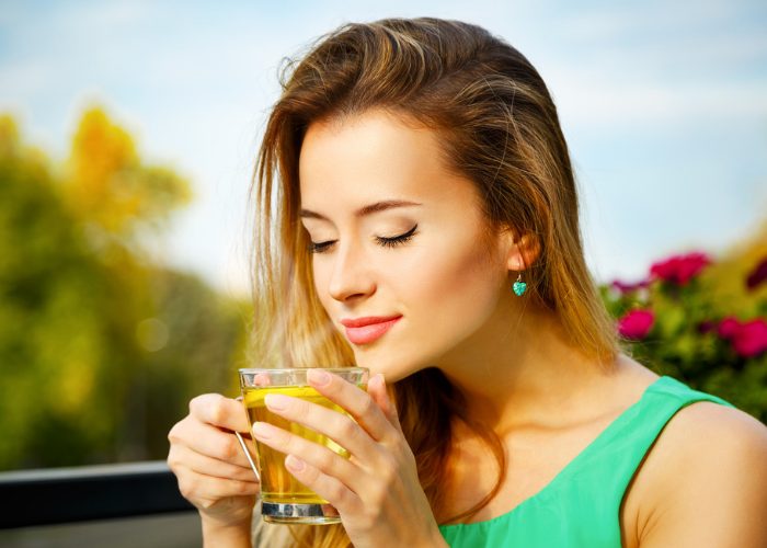Woman drinking green tea outdoors