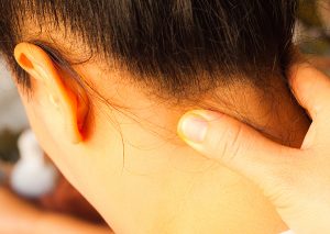 massaging the back of a woman's neck for instant migraine relief