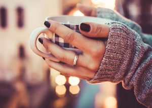 woman's hands holding a mug 