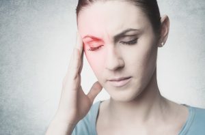 woman touching her temple wishing for migraine headache relief