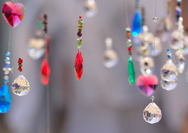 Strings of crystals of different shapes, colors, and sizes dangling