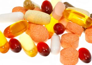 Pile of vitamin and mineral supplements, as well as fish oil capsules