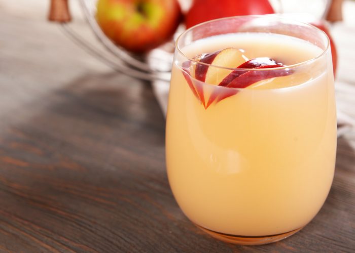 apple cider vinegar drink recipe and apple slices in a glass