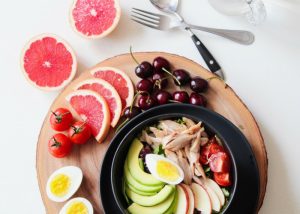 meal kit with sliced avocado apple eggs and grapefruit