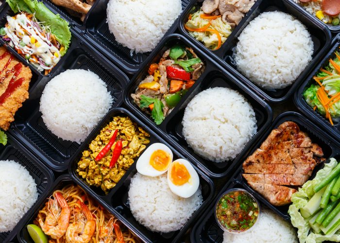 meal prep delivery containers with rice, meat, and veggies
