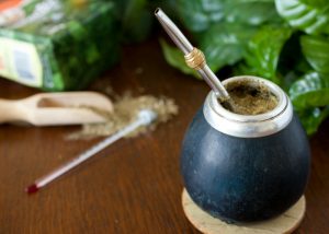 a cup of yerba mate drink with a straw