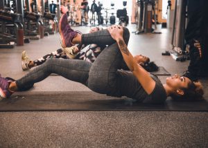 woman stretching her legs at the gym