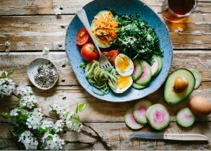 plate of zucchini noodles eggs tomatoes and avocado