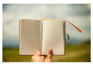 hand holding up an empty journal