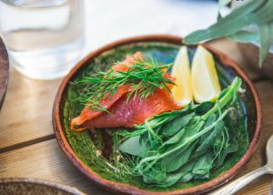plate with smoked salmon and fresh greens