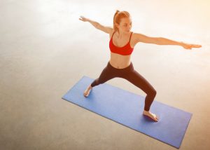 woman performing yoga warrior pose