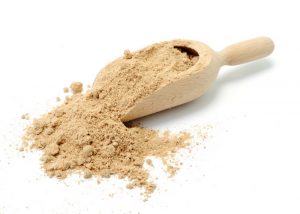 a scoopful of cricket flour on a white background