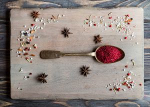a spoonful of the superfood sumac spice on a table