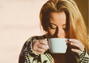 a woman drinking a cup of tea