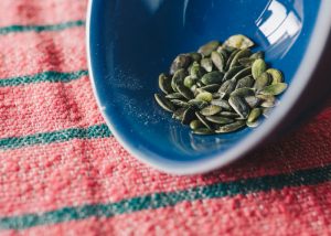 pumpkin seeds in a blue bowl