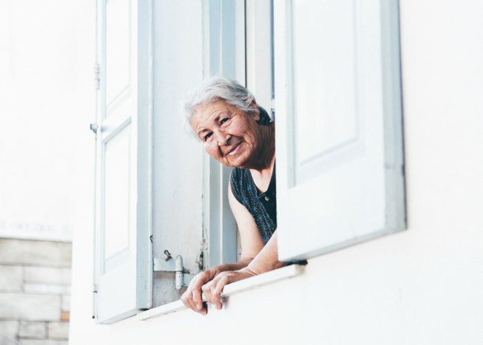 old woman looking out her window