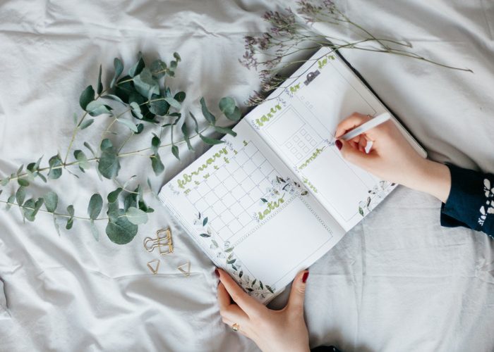 woman writing in her calendar