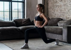 woman doing lunges in her living room