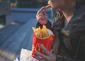 a woman eating mcdonalds fries