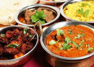 different bowls of indian curry dishes