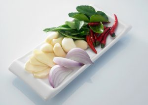 fresh ingredients for a curry on a white plate