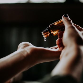 Woman putting essential oils in her palm