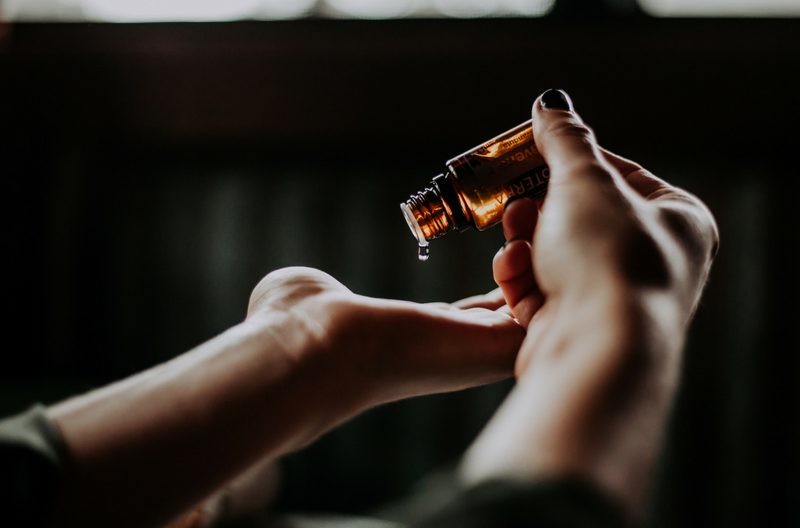 Woman putting essential oils in her palm