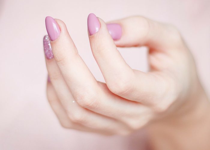 a woman's hand with nicely manicured pink nails