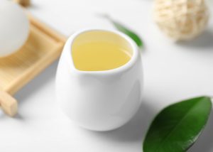 tea tree oil in a small white cup