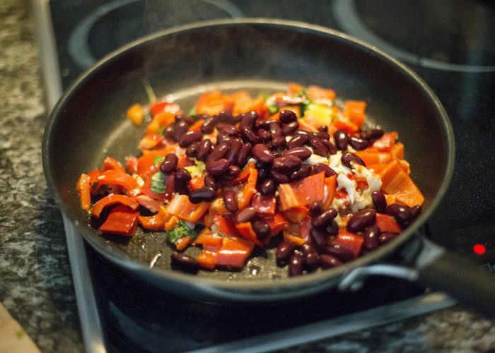 kidney beans and peppers cooking in a pan