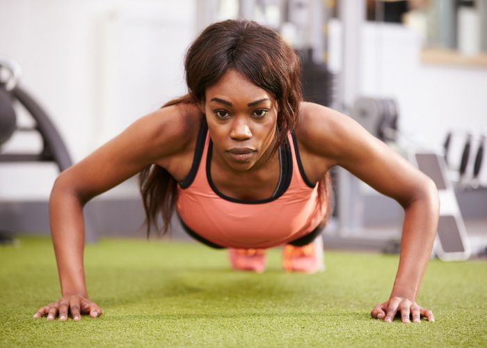 woman doing wide push up chest exercises