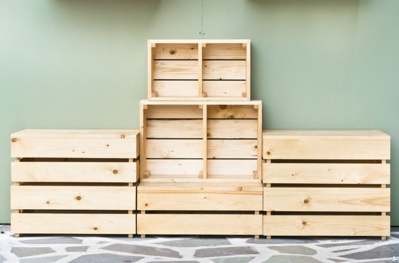 A stack of empty wooden crates against a wall