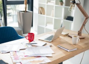 a small clutter of paper on an office desk