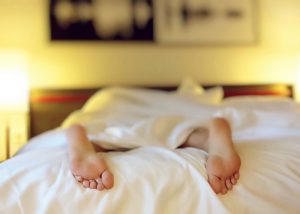 woman's feet at the end of the bed