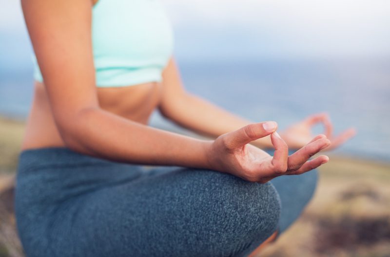 Woman trying to learn to meditate in a seated meditation position