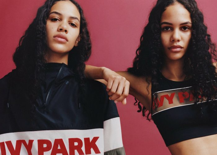 two women modeling Ivy Park workout gear for women against a red background