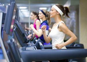 women running on treadmills in the gym