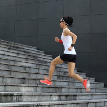 Woman running up stairs doing a workout without the gym