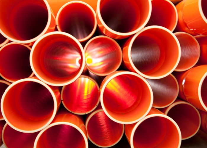 looking down the tube of orange pvc pipes