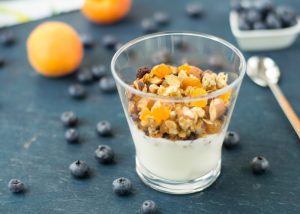 Probiotic-rich yogurt in a small glass with muesli and fruits