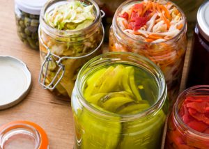 Jars of homemade fermented foods such as pickles and sauerkraut