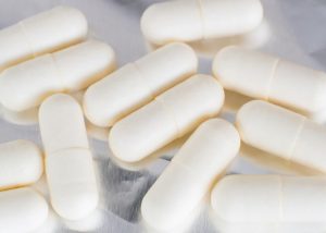 White probiotic supplement capsules