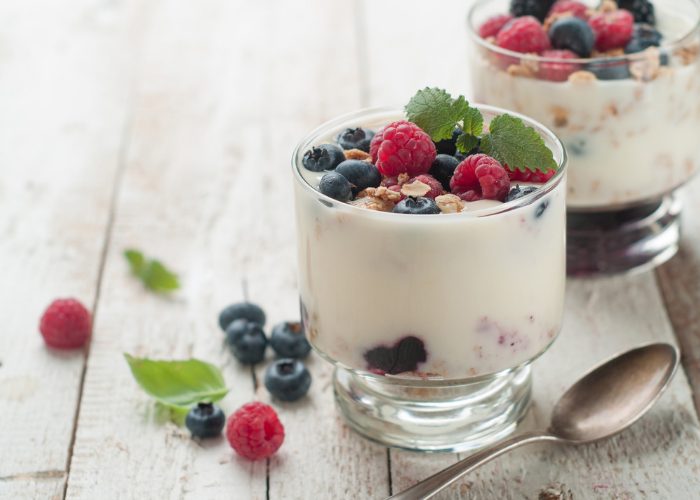 Homemade yogurt and fruit cups topped with berries and nuts