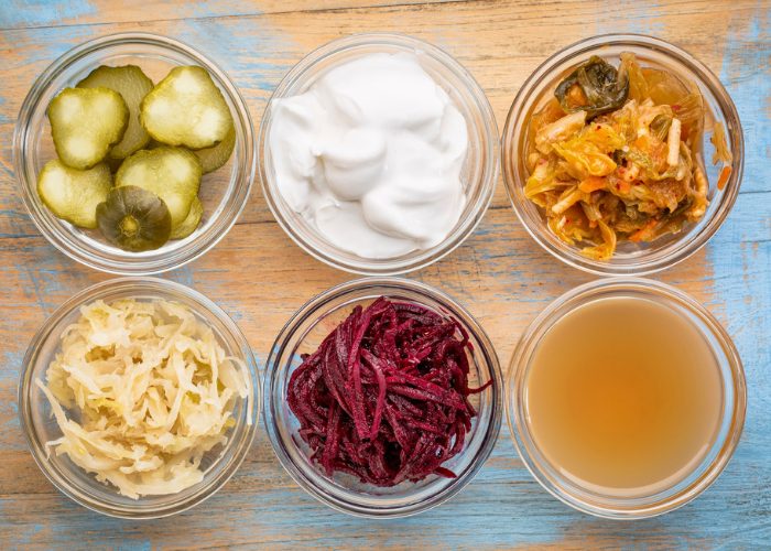 fermented foods like pickles, kimchi, sauerkraut, and yogurt in small clear dishes