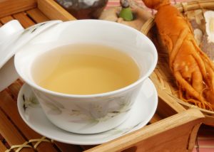 a cup of ginseng tea in a traditional chinese tea cup