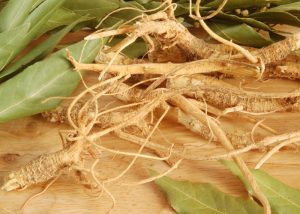 ginseng roots on a table surrounded by bay leaves