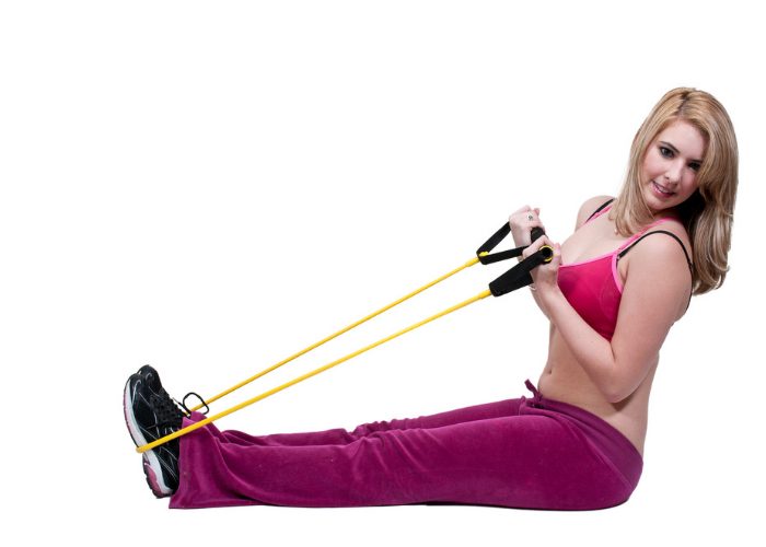 woman using a resistance band on her feet as part of an ankle sprain injury workout