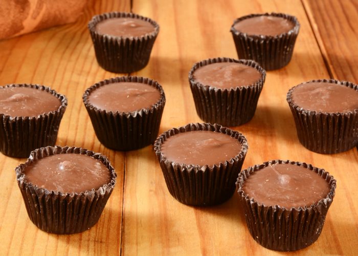 vegan gluten free chocolate and cashew butter cups on a wooden table